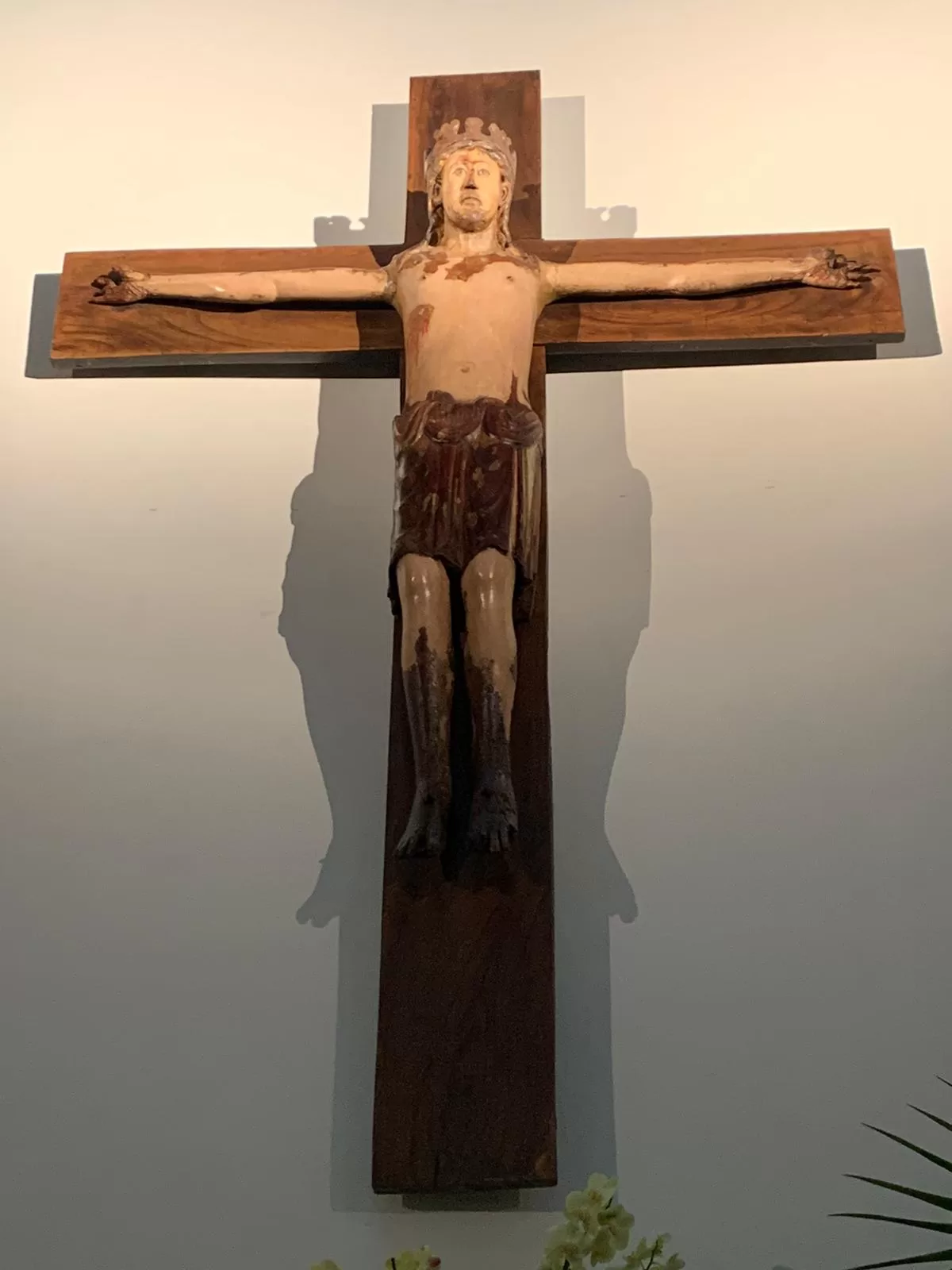 A wooden cross with a person on it Description automatically generated